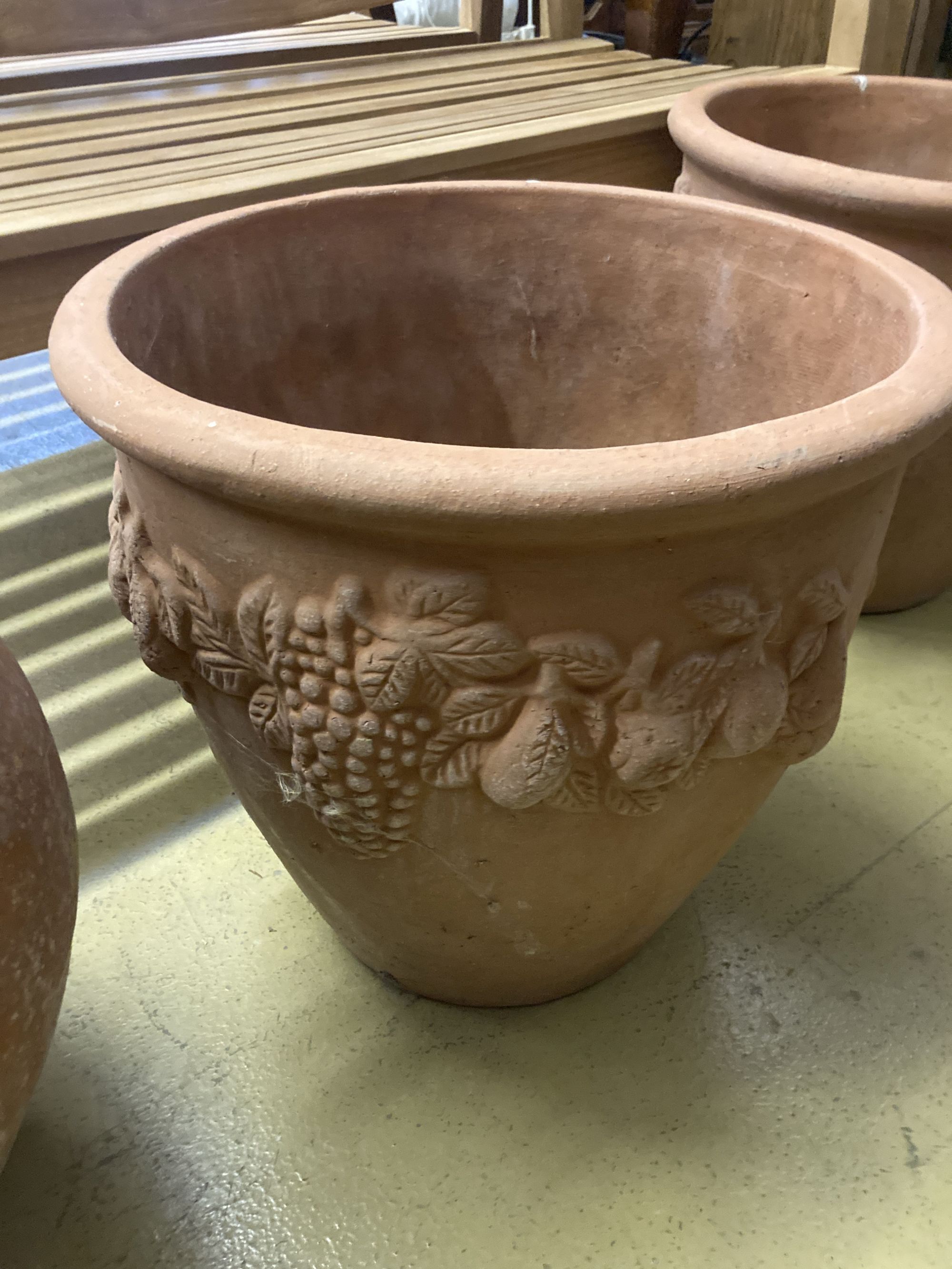 Four circular terracotta garden urns, largest 50cm diameter, 46cm high